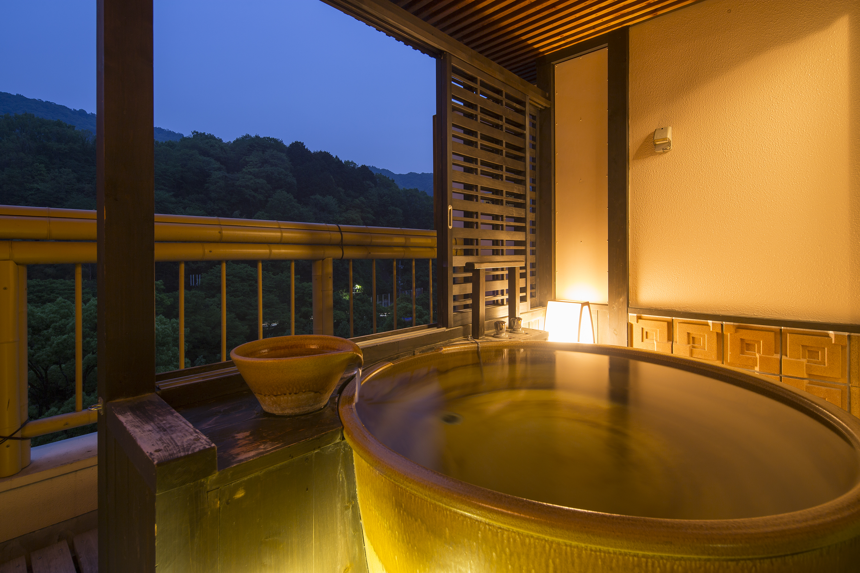 Private open-air bath illuminated at night